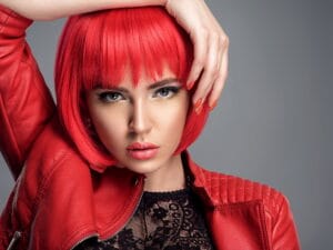 Beautiful sexy woman with bright red bob hairstyle. Fashion mod